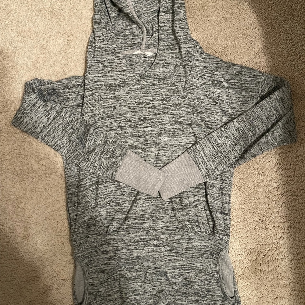 Marked grey hoodie with cinched waist and front pocket.